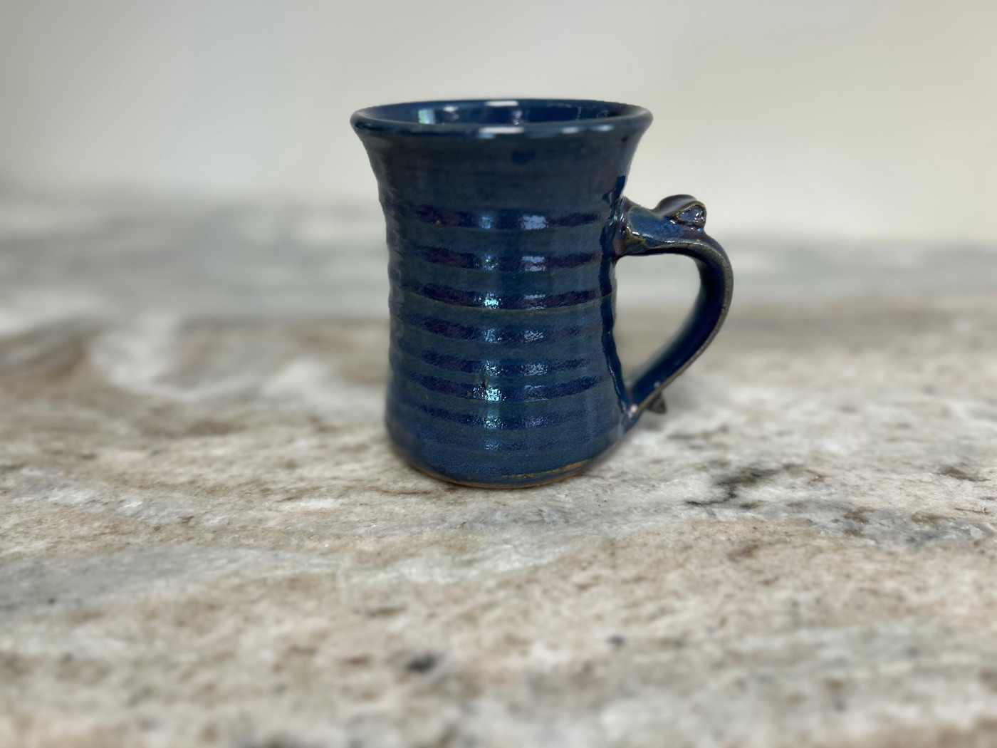 Handmade deep cobalt blue pottery mug with horizontal throwing ridges