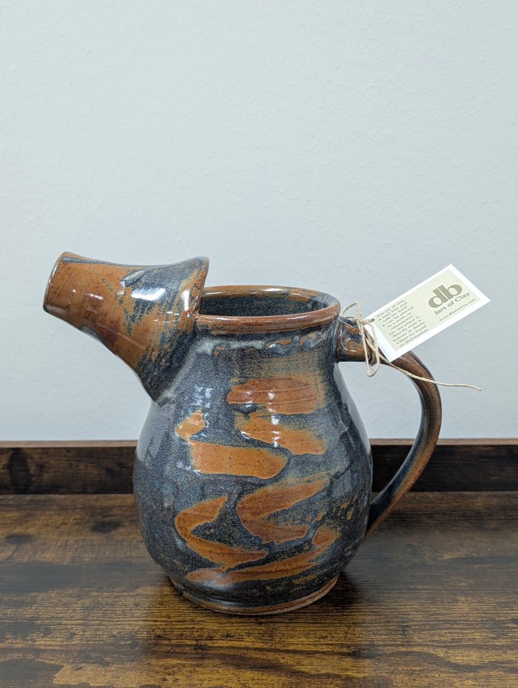 Handmade stoneware batter pitcher in rust and slate marbled glaze